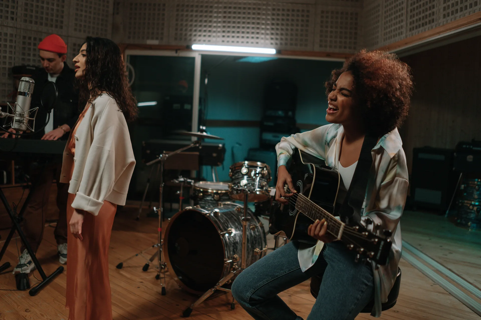 Musicians rehearsing together in a recording studio.